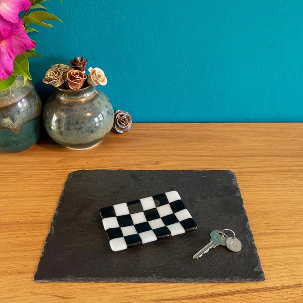 Black and white checkered glass dish on slate tray with keys, handmade British craft decor