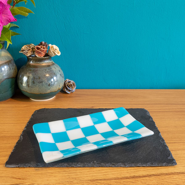 Handmade ceramic plate with blue and white checkered pattern, displayed on slate, British craft