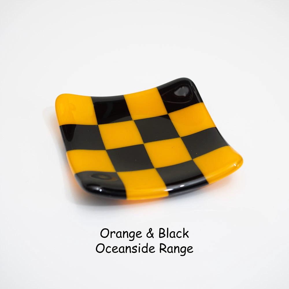 Handmade orange and black checkered glass dish from Oceanside Range, British craft