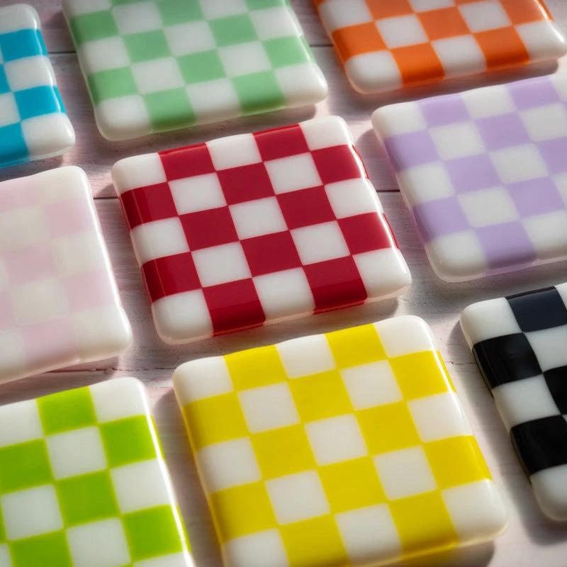 Colorful checkered coasters in red, yellow, green, and more — handmade British crafts