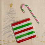 Festive red, green, and white striped glass coaster with candy cane, perfect for British holiday decor