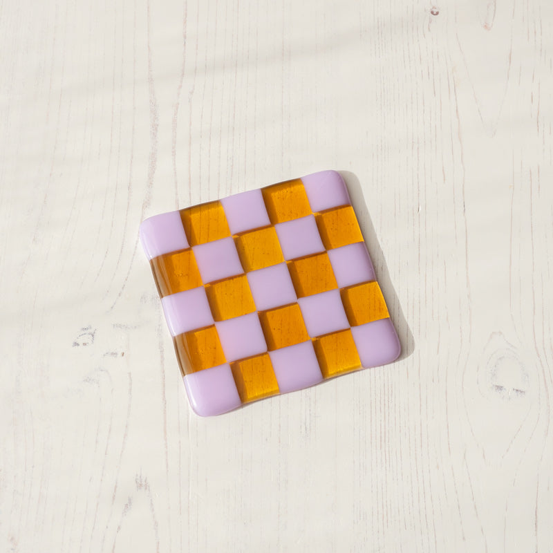Handmade glass coaster with purple and amber checkerboard pattern, British craft design