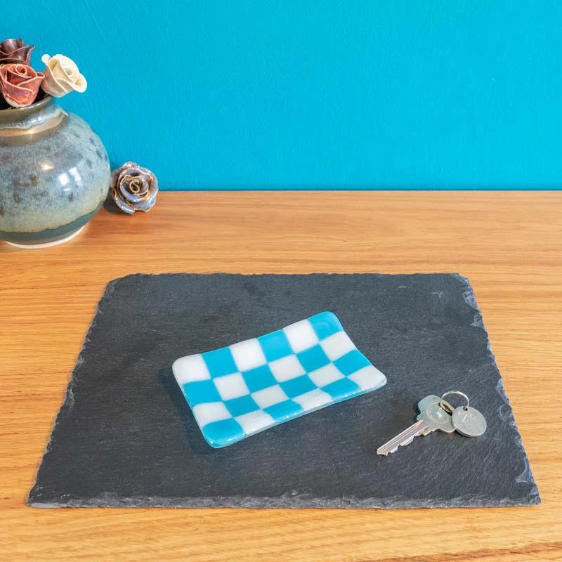 Blue and white checkered glass trinket dish on slate, keys beside, handmade British craft